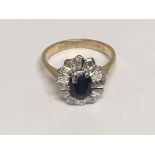 An 18carat gold ring set with a blue sapphire and small diamonds ring size G-H