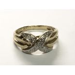 A 14carat yellow gold ring with X shaped pattern of diamonds.ring size O.