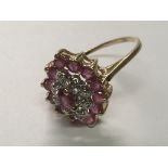 A 9carat gold ruby and diamond cluster ring. Ring Size N.