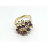 A circa 1960s 14ct gold ten stone garnet dress ring, approx 6.5g and approx size O.