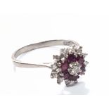 An 18cart gold ring set with a cluster of Ruby’s and diamonds. Ring size P.