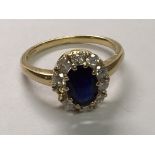 An 18carat gold ring set with a central cut oval sapphire and diamonds.ring size O. one stone