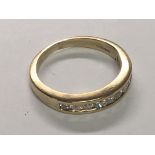 A 9carat gold half hoop eternity ring set with a row of brilliant cut diamonds. 0.33 of a carat