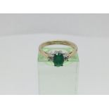 A 9ct gold ring set with a central green stone with a diamond to either side, approx 3g and approx