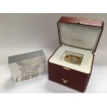 An 18ct gold ladies Cartier watch with original box plus a boxed Cartier watch cleaning kit. The