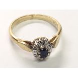 An 18carat gold ring set with a blue sapphire and chip stone diamonds ring size K.