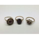 Three 9ct gold rings set with garnets, approx 8.4g and approx sizes N-O.