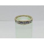 A 9ct gold half eternity ring set with tanzanite and diamonds, approx 2.4g and approx size P-Q.