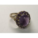 A 9carat gold ring set with an amethyst cabochon. Ring size P.