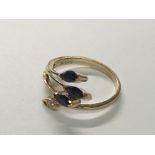 An 18carat yellow gold ring setvwith three sapphire and a diamond. Ring size H.