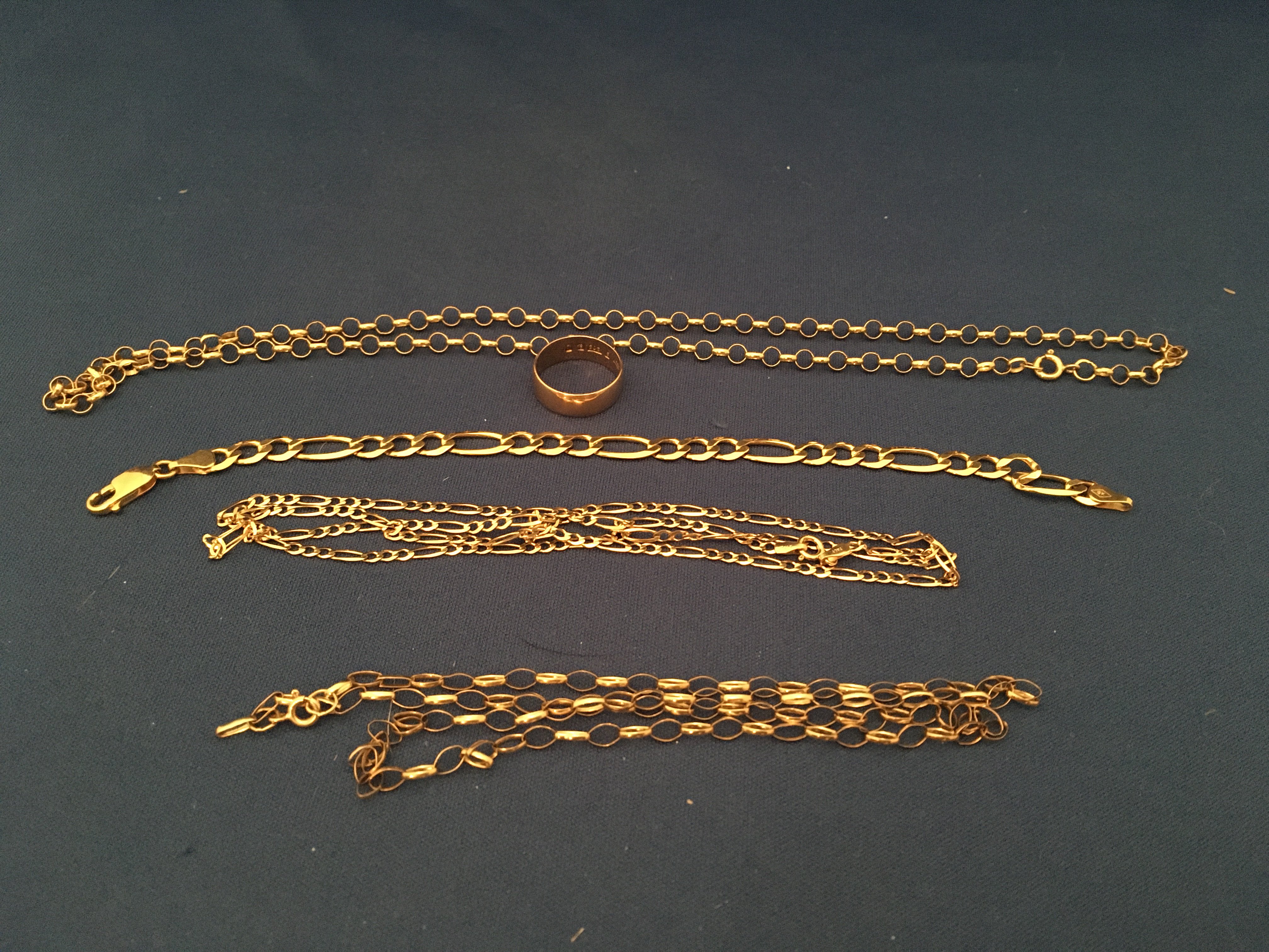4 9ct gold chains and a 9ct gold wedding band. (Approx 23.9g)