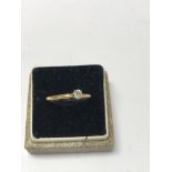 A 18 ct gold ring inset with a single diamond