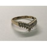 A 9carat gold ring of wish bone shape set with a pattern of diamonds. Ring size N.