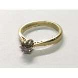 An 18carat gold ring set with a brilliant cut solitaire diamond ring size K.