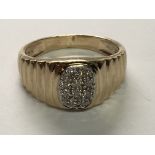 A Gents 9carat gold ring set with a pattern of diamonds. Ring size V.