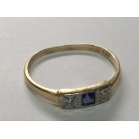 An 18carat gold Ring Early 20th Century set with a blue sapphire flanked by diamonds. ring size N.