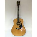 A Yamaha FG400A acoustic guitar and hard carry case.