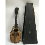 A cased 19th Century mandolin, label inside soundhole reads Melilla.