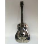 A Supro Resonator acoustic guitar, comes supplied with a soft padded carry case.