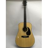 A Hondo acoustic guitar, model H18. Fitted with Grover tuners and comes supplied with a hard carry
