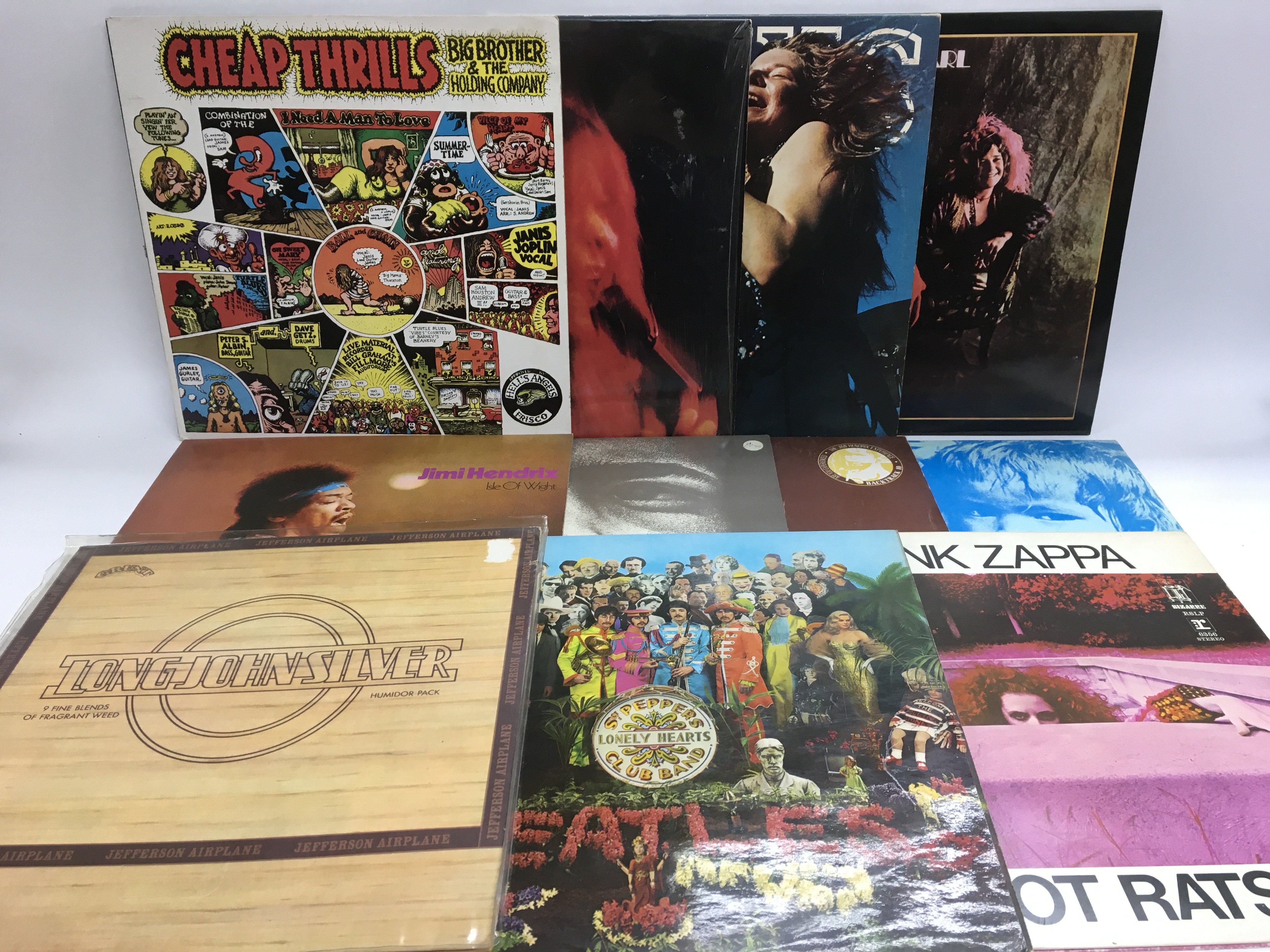 A collection of LPs by various artists from the 1960s including The Beatles, Jimi Hendrix, Big