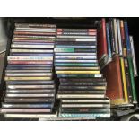 Two plastic trays of CDs by various artists including U2, Eminem, The Pogues and others.