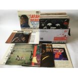 A collection of jazz LPs by various artists including Count Basie, Woody Herman, Coleman Hawkins and
