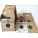 A box of 78 rpm records including various Rock n Roll and jazz titles.