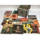 A record box containing various 7inch singles and EPs from the 1960s onwards including The Beatles.