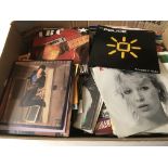 A box containing a collection of 7inch singles by various artists from the 1980s onwards including