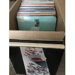 A box of LPs by various artists including The Beatles, Three Dog Night, Canned Heat and others.