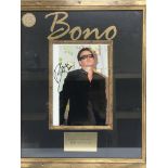 A framed and glazed signed photo display of Bono, approx 42cm x 50cm.