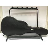 A folding multiple guitar stand and a hard shell guitar case (2).