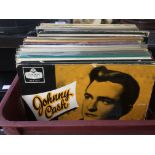 A plastic crate containing a collection of country music LPs by various artists.