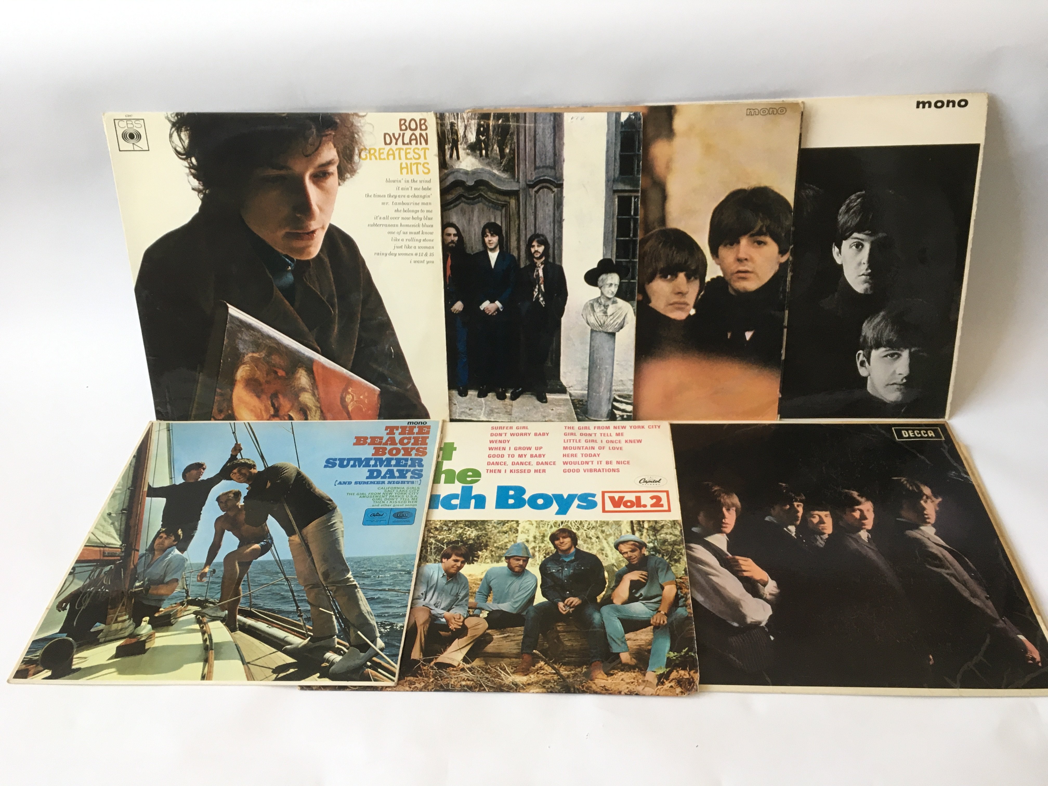 Seven LPs comprising albums by The Beatles, The Rolling Stones, The Beach Boys and Bob Dylan.
