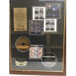 A framed and glazed limited edition UB40 multi CD display, approx 54.5cm x 69.5cm.