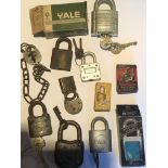 A collection of unusual and old padlocks most with keys.