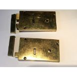 A Pair of solid brass rim locks with strike boxes and a single key fitting one lock. 14x8cm.