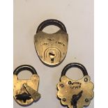 Three small brass Victorian padlocks with two keys.