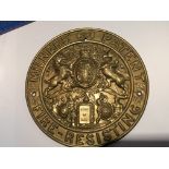 A pressed brass safe makers plaque maker Millers the centre with raised coat of arms. Diameter