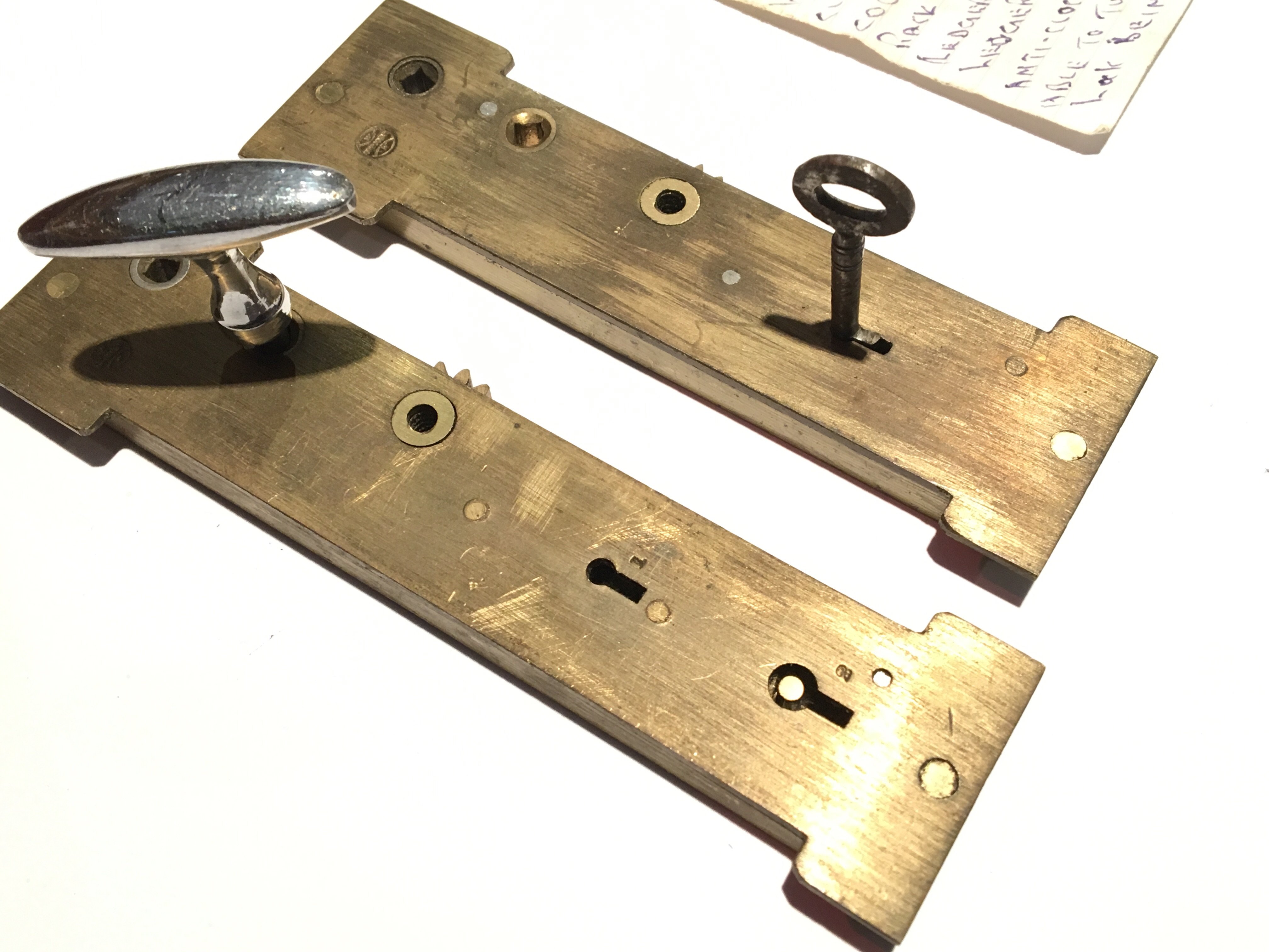 Two rare 19th Century brass ledger book locks with handwritten operation notes with one key.