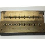 A 1920s brass and steel Sonnette Keyway Panel. With a rectangular front plate 16 key profile