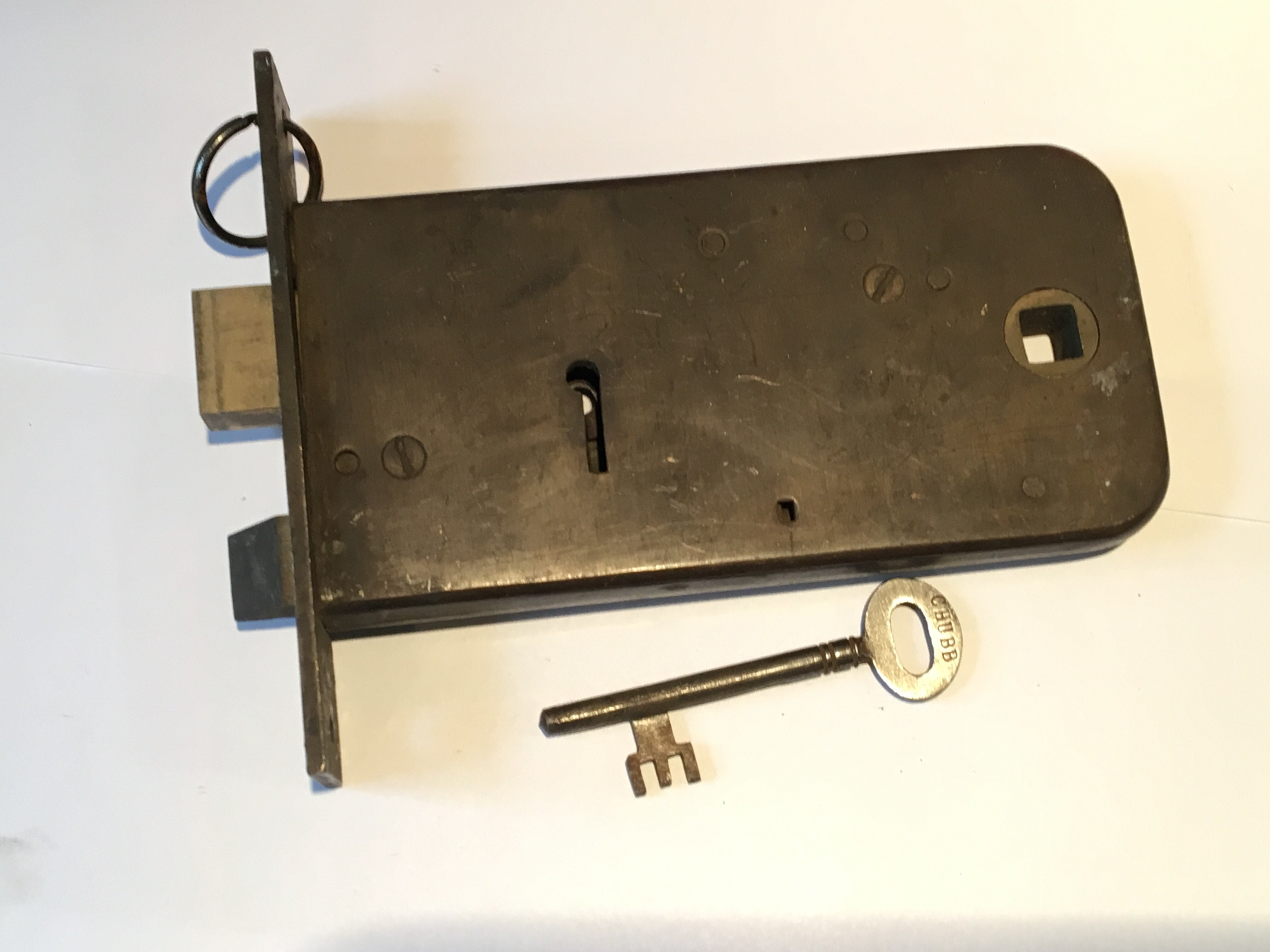 A chubb solid brass horizontal mortise sash lock with unusual offset original key numbered 15.