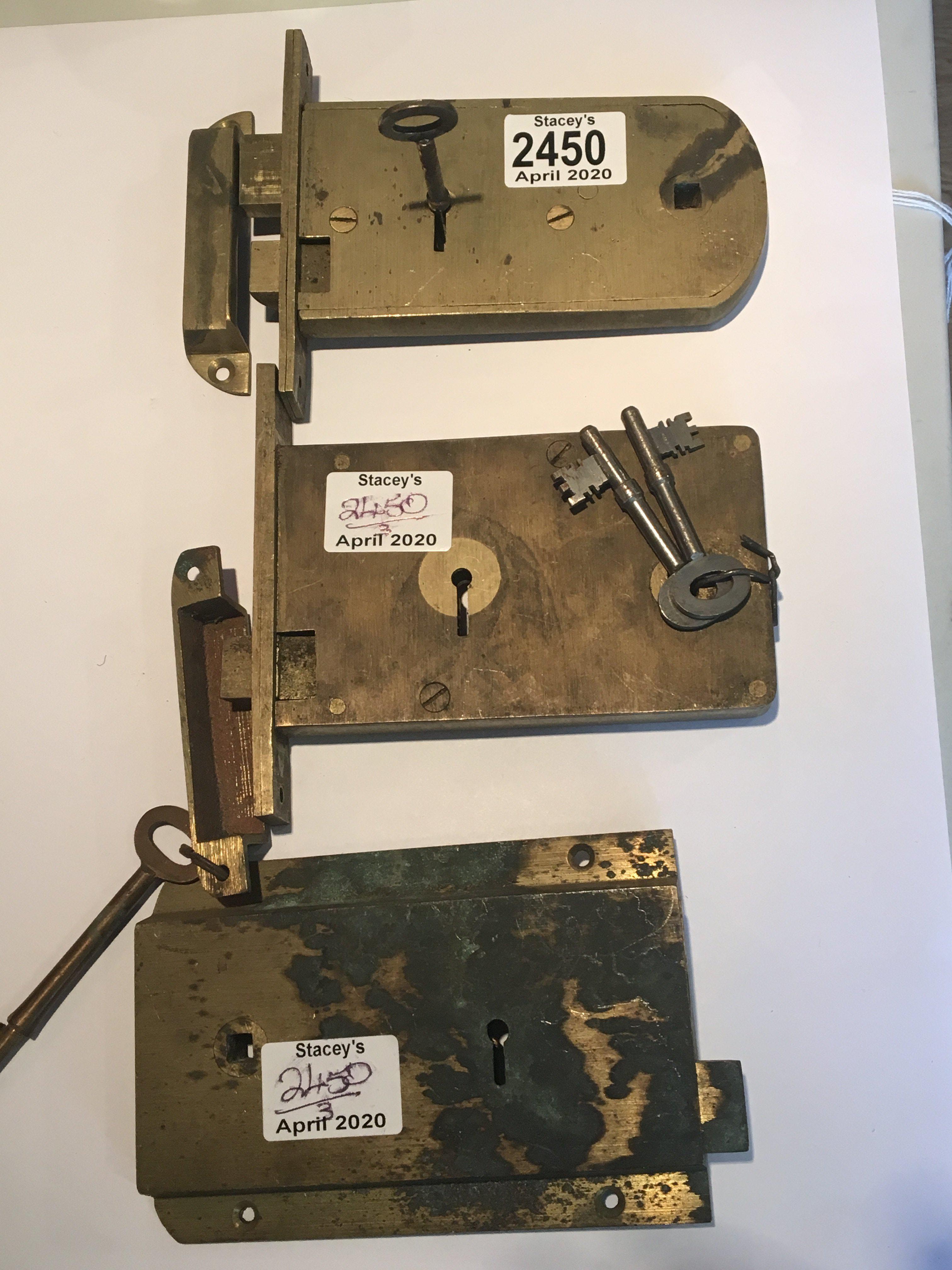 Three solid brass locks two horizontal mortise locks and one rim lock with keys.