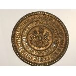 A pressed brass safe makers plaque. Thos Perry & Sons the centre with Royal coat of arms.