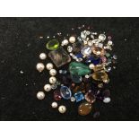 A bag of gemstones to include diamonds, sapphire,