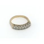 An 18ct gold 7 stone diamond ring. (O). 3.4g.