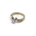 A 9 carat gold ring. Set with a solitaire diamond