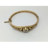 A 14ct gold bracelet set with a central diamond an