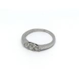 An 18carat white gold ring set with three brillian